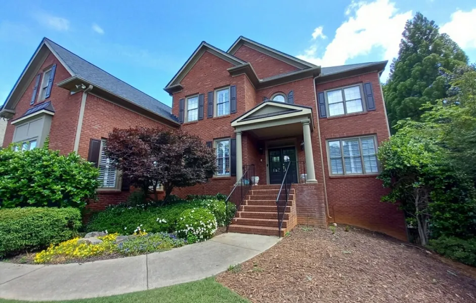a brick house with a front yard