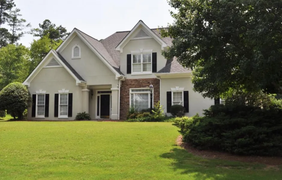 a white house with a lawn