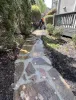 a stone path with a couple people walking on it