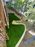 a backyard with a deck and trees
