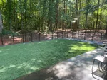 a backyard with a fence and trees
