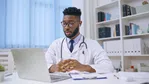 a doctor looking at a laptop