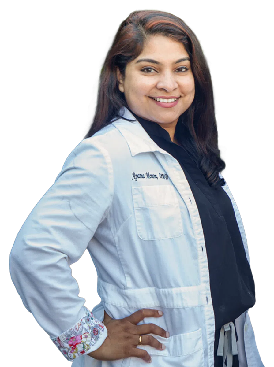 Two smiling female doctors in white coats with hands on hips against a transparent background