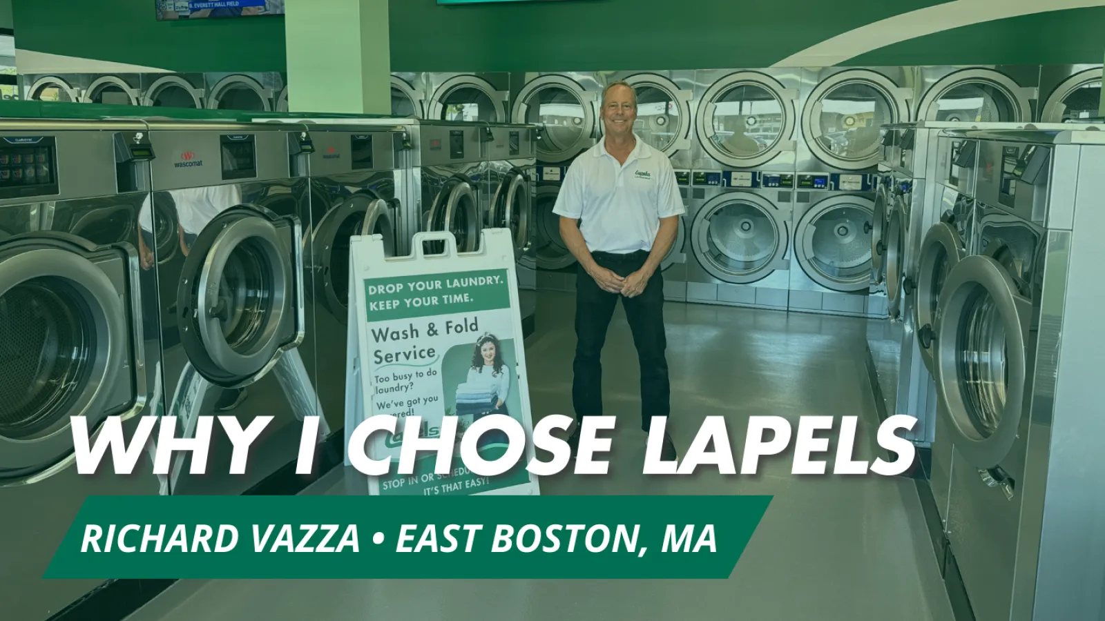 Man standing in a green laundromat with rows of washers and dryers and a wash and fold service sign.