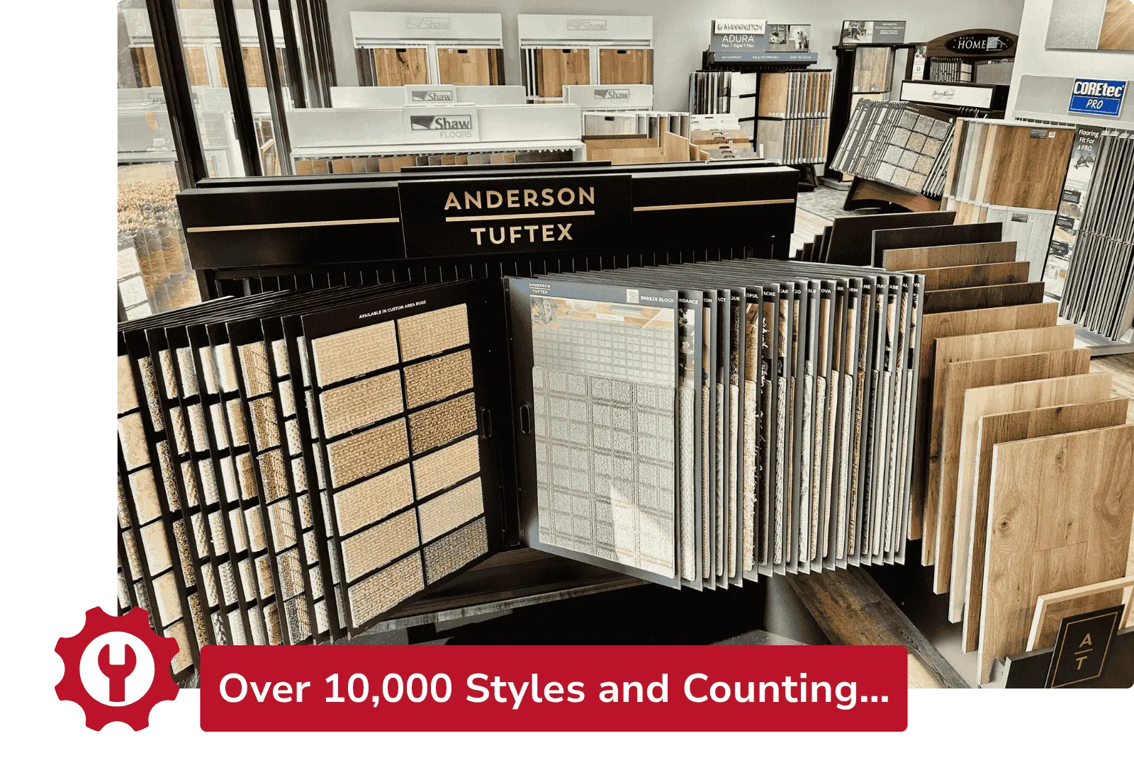 Interior showroom displaying Anderson Tuftex flooring samples including carpet and wood planks on racks