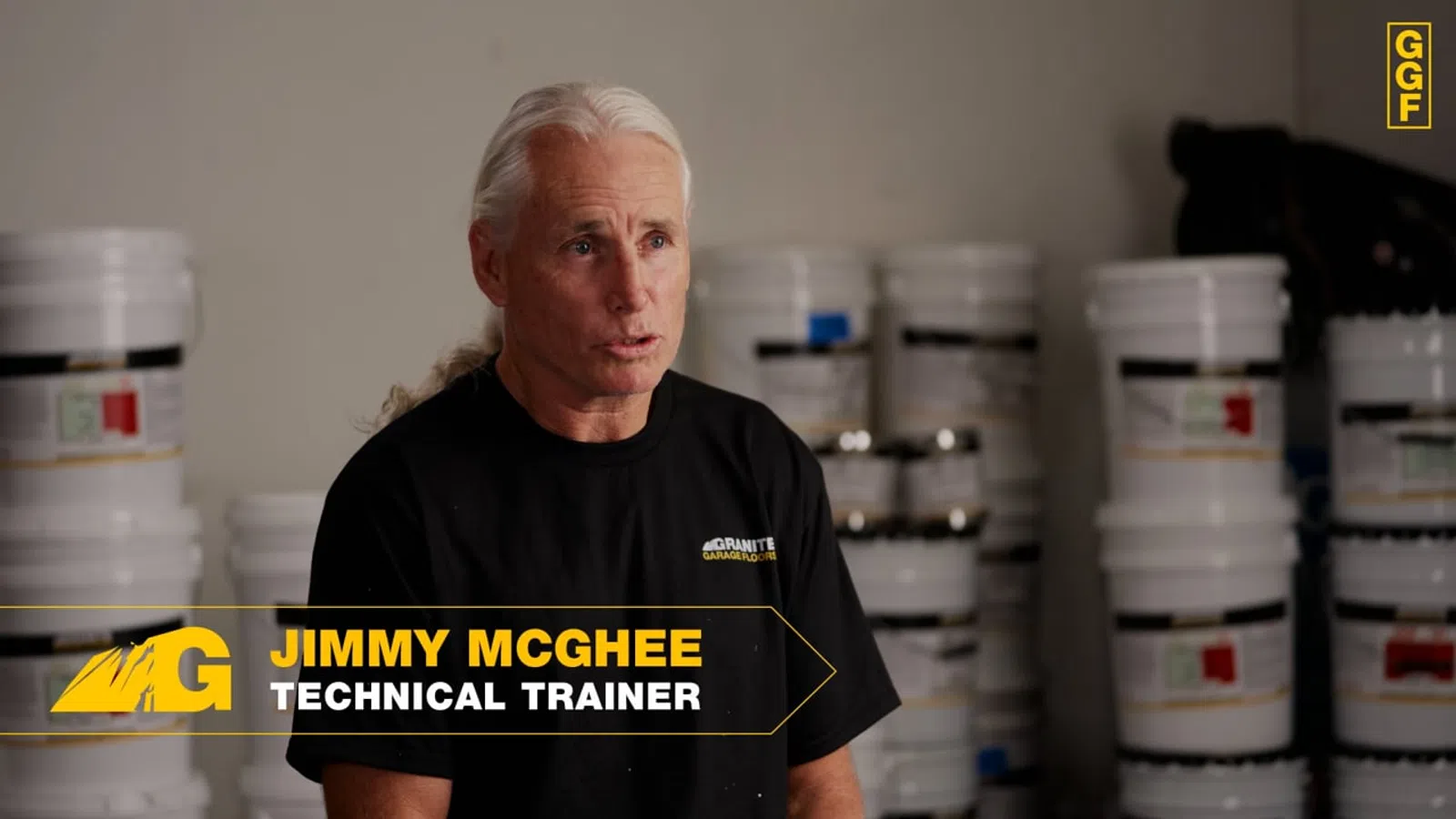 Technical trainer Jimmy McGhee speaking in a workshop with white buckets stacked behind him.