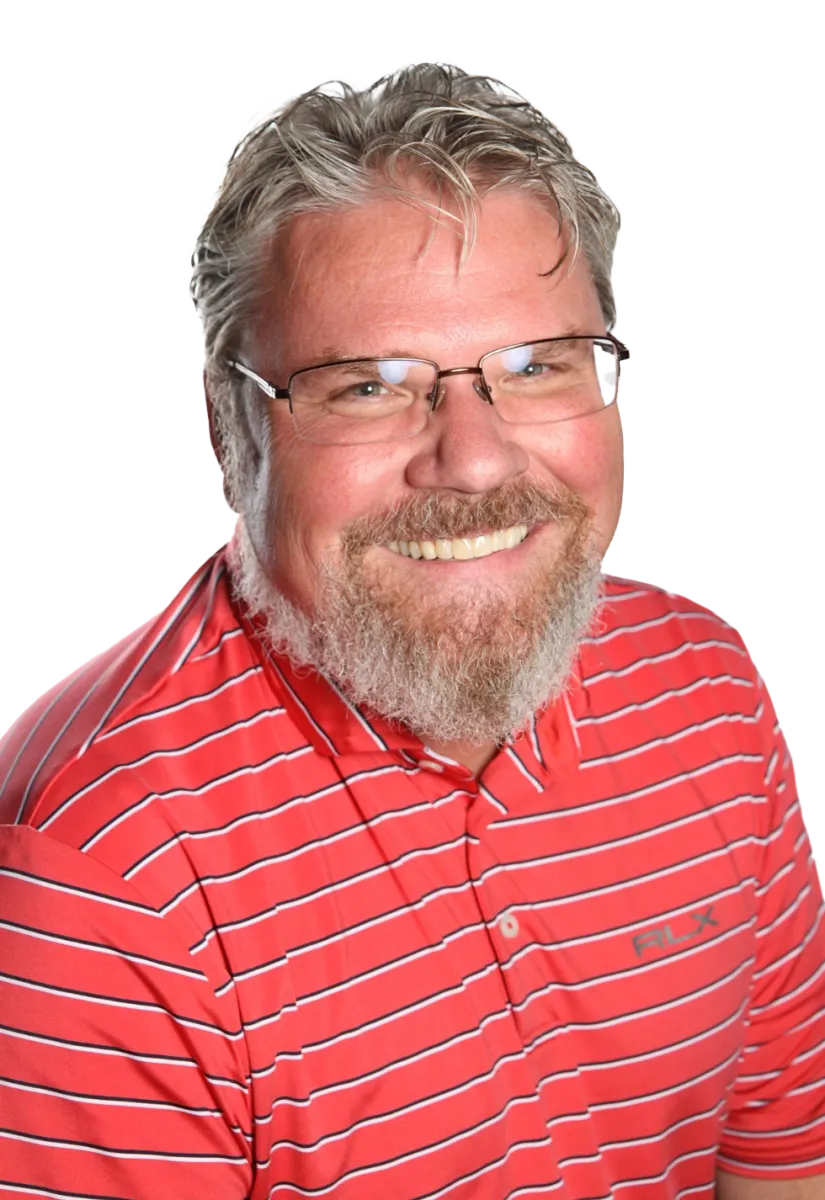 Smiling middle-aged man with glasses and beard wearing a red striped polo shirt against a white background