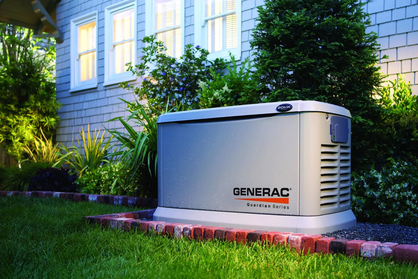 Generac home standby generator installed beside a house with wooden fence and cloudy sky.