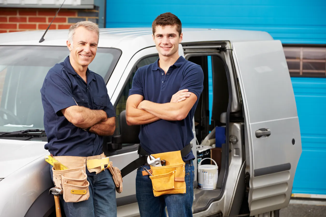 a couple of men standing in front of a car