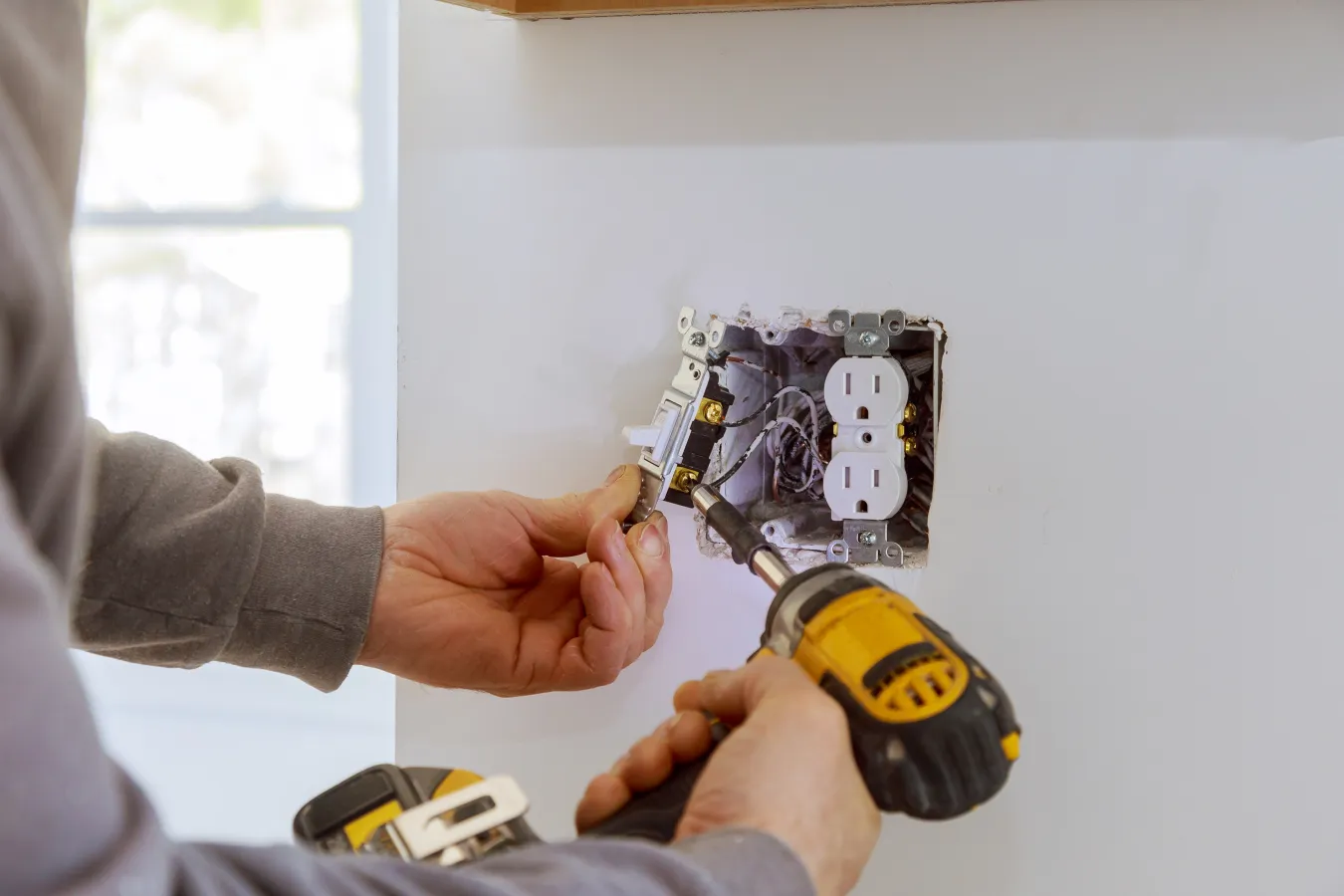 electrician fixing outlet