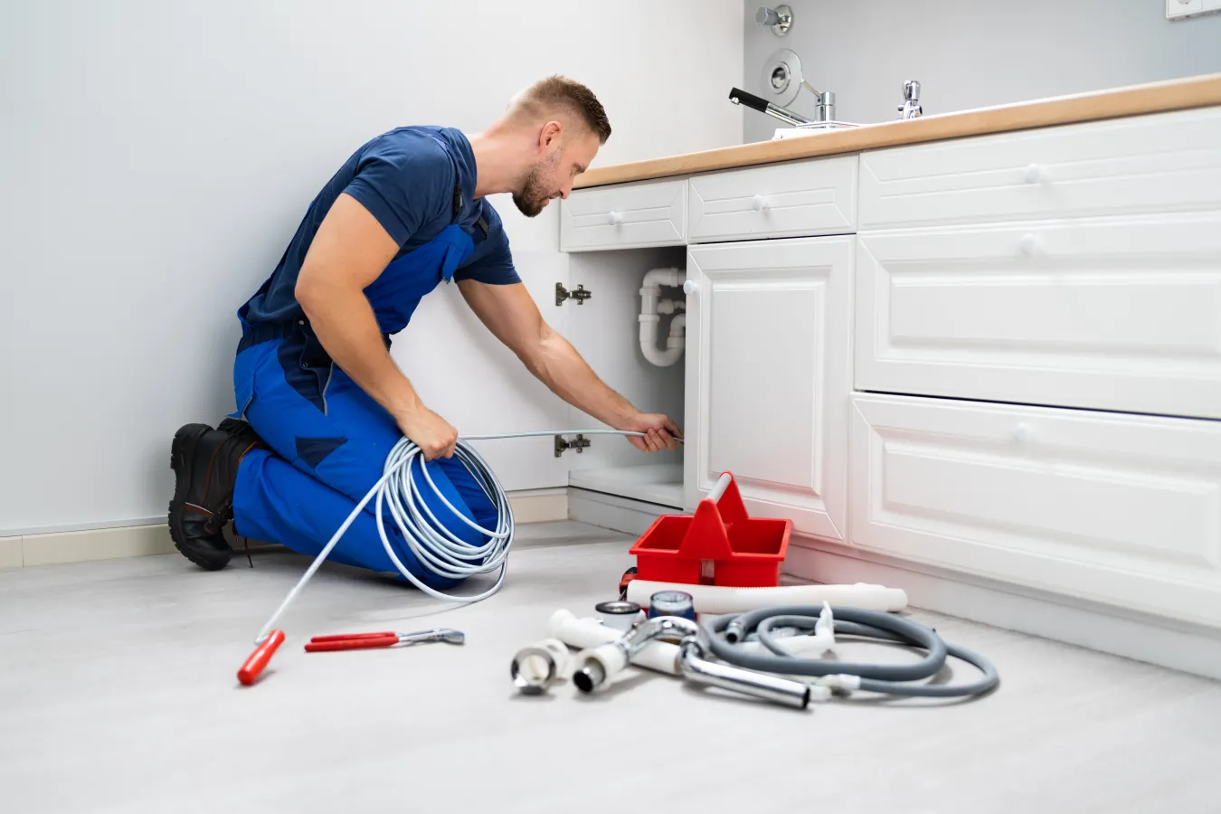 plumber fixing sink pipes