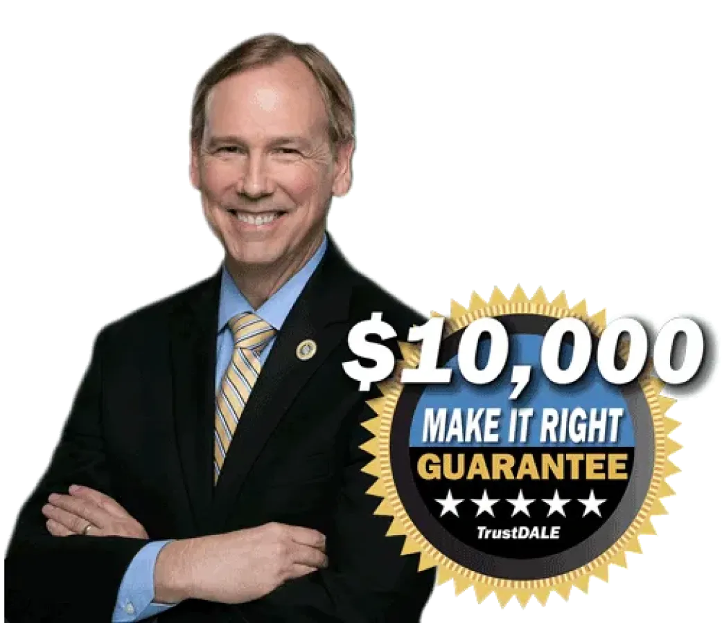 Smiling man in suit with $10,000 Make It Right Guarantee badge featuring gold seal and five stars.