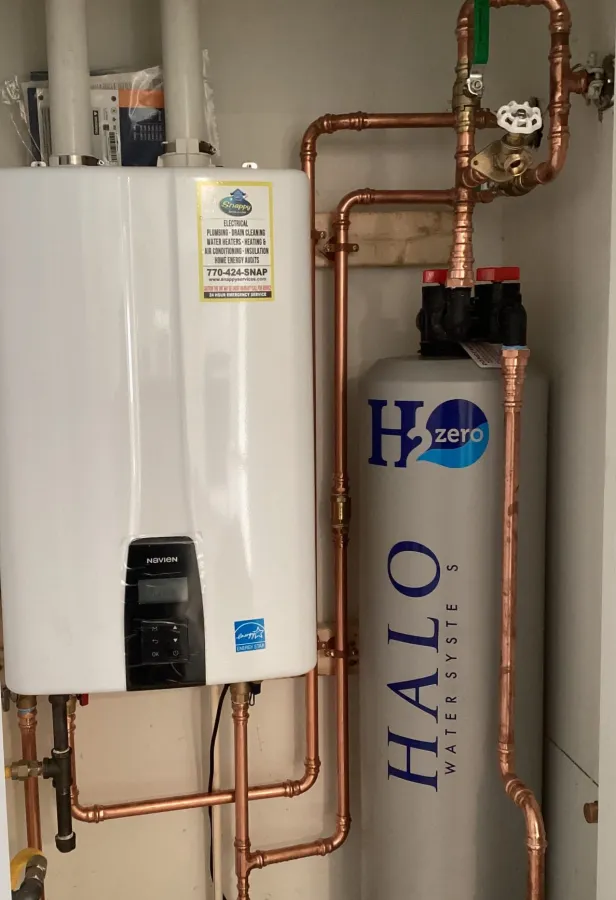 A modern water heating system featuring a Halo water filtration unit and copper plumbing in a utility room.