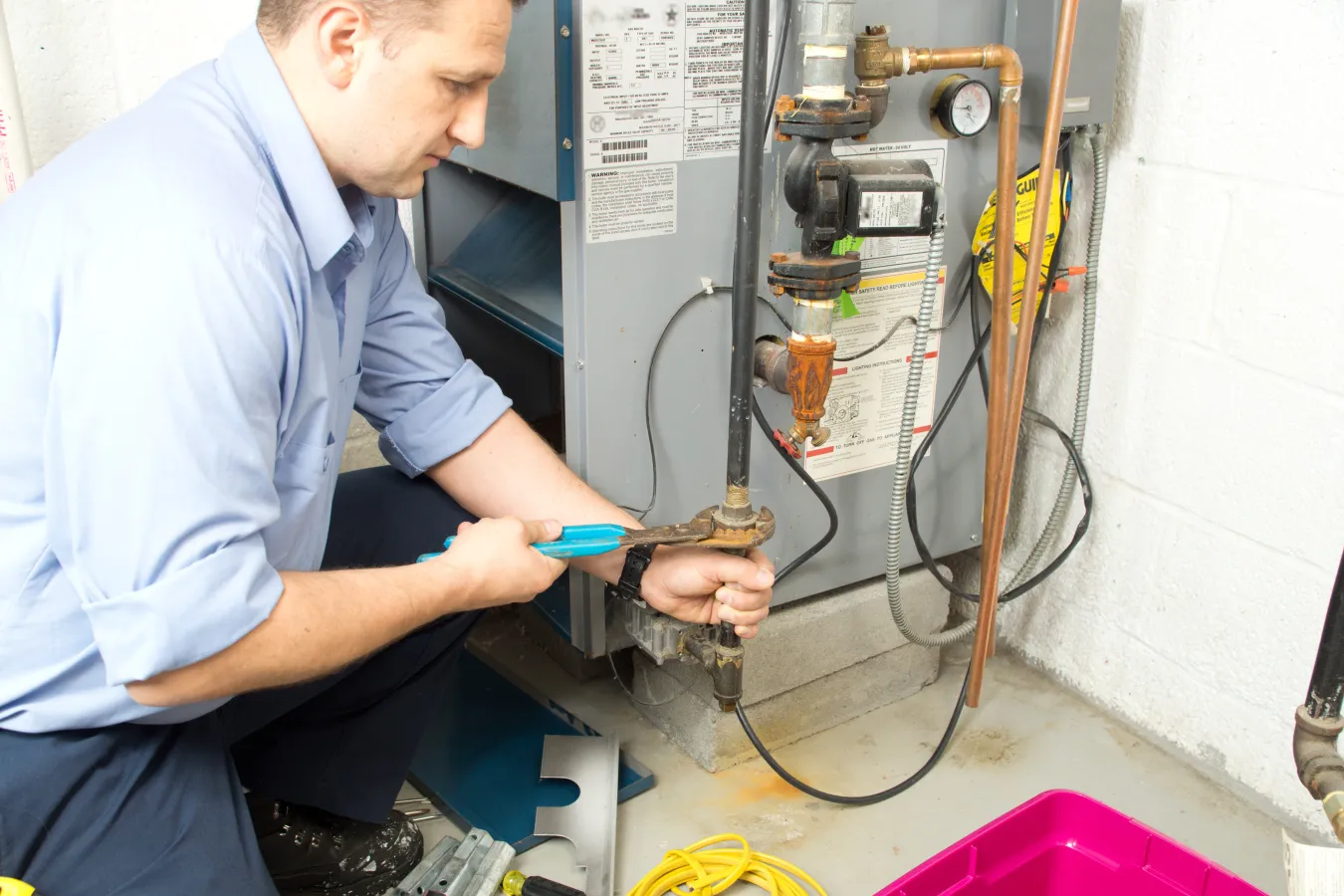 technician fixing air furnace