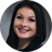 Smiling woman with dark hair in a close-up portrait against a neutral background