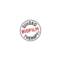 Logo displaying the phrase Guided Biofilm Therapy in black and red text inside a white circle on black background
