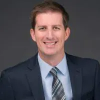 a man in a suit smiling