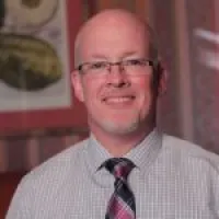 a man wearing glasses and a tie