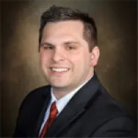 a man in a suit smiling
