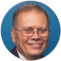 Smiling elderly man with glasses in a suit against a blue circular background