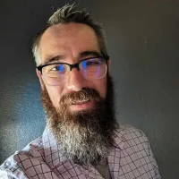 a man with a beard and glasses