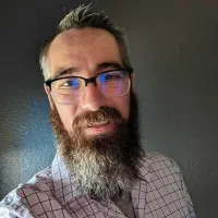 a man with a beard and glasses