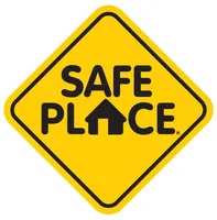Yellow diamond-shaped sign with black border and text Safe Place including a house icon in the word Place.
