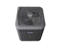 Gray Carrier outdoor air conditioning unit with visible fan and protective grille from top view.