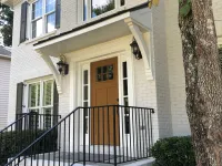a white house with a black railing