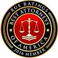 Round emblem with gold scales of justice on red center, text 'Best Attorneys of America 2016 Member' on black ring