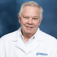 Smiling elderly man in white lab coat with Regenerative logo on blue background