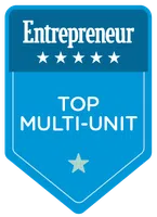 Entrepreneur badge with five stars and text Top Multi-Unit on blue shield background