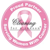 Pink circular logo with breast cancer ribbon and text Proud Partner Serving Women With Cancer Cleaning for a Reason