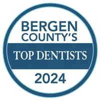 Bergen County's Top Dentists 2024 award badge with blue and white circular design.