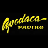 Bold yellow Apodaca Paving logo with stylized and block lettering on a black background.