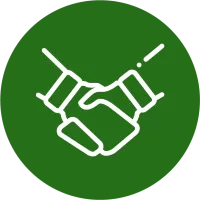 White handshake icon on a green circular background symbolizing partnership and agreement.