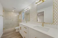 a bathroom with a tub sink and toilet