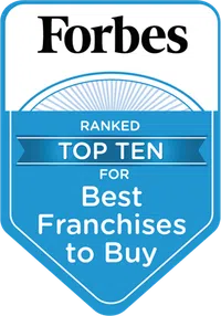 Forbes badge showing top ten ranking for best franchises to buy with blue and white design.