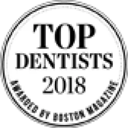 Circular badge stating Top Dentists 2018 awarded by Detroit Monthly magazine