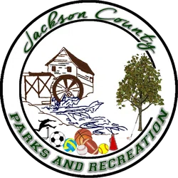 Logo of Jackson County Parks and Recreation featuring a watermill, tree, sports equipment, and golf club.