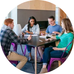 a group of people sitting around a table