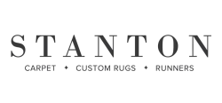 Stanton logo with text Carpet, Custom Rugs, and Runners below the brand name in black font.