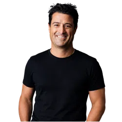 Smiling man with dark hair wearing a black t-shirt against a solid black background.