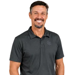 Smiling man with short hair and goatee wearing a dark gray polo shirt with a subtle logo on the chest.