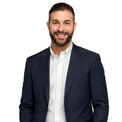 Smiling bearded man in a navy plaid blazer and white button-up shirt against a transparent background