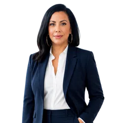 Confident businesswoman with black hair in navy blazer and white blouse posing with hand in pocket