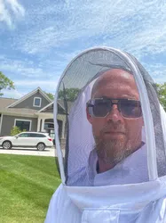 Tim Freke wearing a white mask and sunglasses