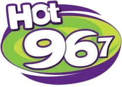 Hot 96.7 radio station logo with bold white text on green and purple oval background