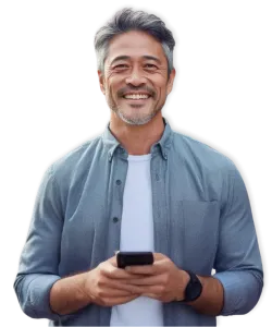 Smiling middle-aged man with gray hair holding a smartphone wearing casual blue shirt and black smartwatch
