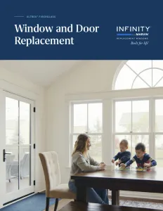 a person and two children sitting at a table in a room with windows